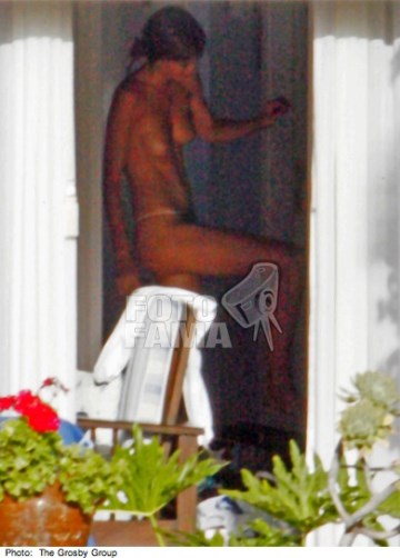 Miranda Kerr - topless on  a balcony
