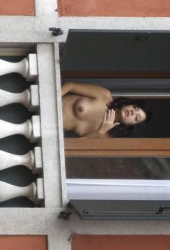 Lily Allen - topless on  a balcony